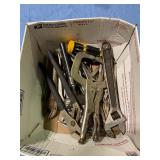 Assorted pliers, vice grips, and wrenches