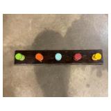 Wall-mounted coat rack with colored pegs