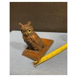 Vintage brass owl figurine on book