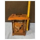 Copper-colored metal lantern with candle