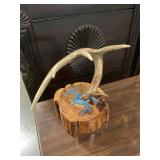 Handcrafted deer antler on wood stump