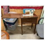White Sewing Machine in Cabinet