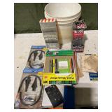 Misc items, sandpaper, hand sander in bucket