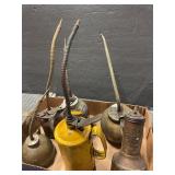 Six vintage oil cans
