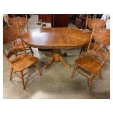 Pedestal table with four chairs has leaf