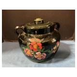 Stoneware crock with chip on ld
