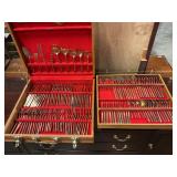 Gold tone silverware set in wooden chest