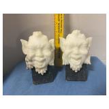 Carved stone satyr-like head sculpture bookends