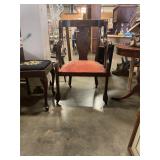 Antique chair on wheels w/damage spot on cushion