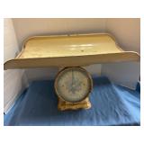 Vintage yellow metal baby scale