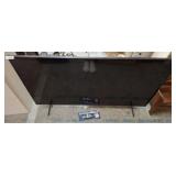 SAMSUNG 65 IN TV ON STAND W/ RCA REMOTE