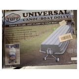 UNIVERSAL CANOE AND BOAT DOLLY BESIDE CLOTHING