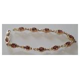 14 K GOLD AND GARNET TENNIS BRACELET
