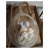HANGING SHELLS IN ROPE HELD GLASS CONTAINER