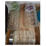 Three Glass Canisters with Colored Lids