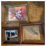 Framed Mirror, Empty Frame, and Floral Artwork