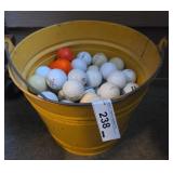 Yellow Metal Bucket with Assorted Golf Balls