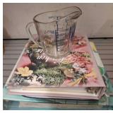 Measuring Cup and Assorted Cookbooks