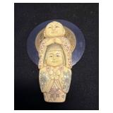 Carved Figurine with Decorative Coin Design
