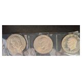 Three Kennedy Half Dollar Coins