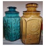 Two Embossed Glass Storage Jars with Lids