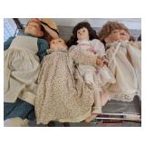 Four Porcelain and Cloth Dolls