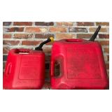 Two Red Plastic Gasoline Cans with Spouts