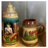 Two German Ceramic Beer Steins with Relief Designs