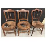 Three Wooden Chairs with Worn Seats