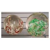 Two Glass Paperweights with Floral Motif