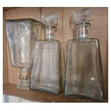 Three Clear Glass Bottles with Stoppers
