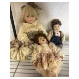 Three Porcelain Dolls in Period Dresses