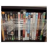 DVDs in Black Wooden Shelf Unit