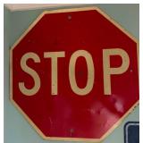 Red Metal Stop Sign with White Lettering