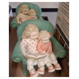 Figurines of Two Children Reading Together