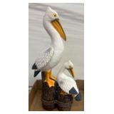 Painted Pelican Figurines on Wooden Posts