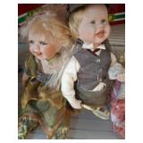 Two Porcelain Dolls in Themed Attire