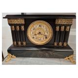 Black and Gold Mantel Clock with Ornate Detai