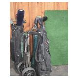 (2) GOLF CLUB BAGS WITH CLUBS, AND PUTTING GREEN