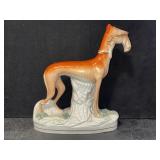 STAFFORDSHIRE GREYHOUND HOLDING RABBIT