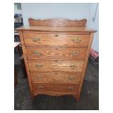Oak five-drawer chest with brass hardware