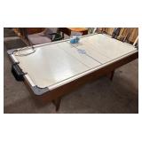 NHLPA-branded air hockey table with pucks and push
