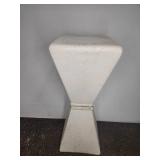 White hourglass-shaped pedestal stand