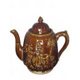 Brown Glazed Ceramic Teapot With Embossed Figures