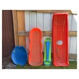 Four Plastic Snow Sleds