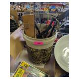 BUCKET OF ICE FISHING RODS AND TIP UPS