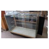 GLASS DISPLAY CASE WITH SHELVES AND CASTERS