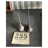 Two small oil cans