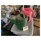 Two flower watering cans