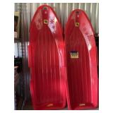 Two plastic toboggans